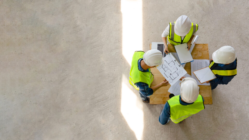 Top down view of engineers meeting with architect